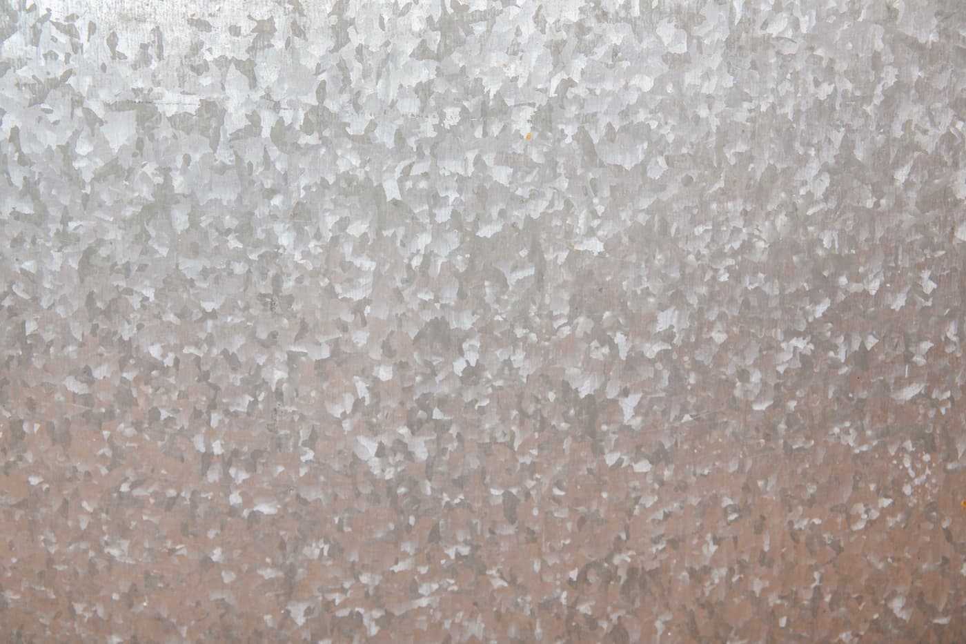 A flat sheet of steel plate photographed in bright daylight